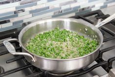 peas are being cooked in a pan on the stove