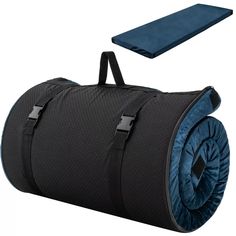 a black and blue duffel bag sitting on top of a white floor next to a mat