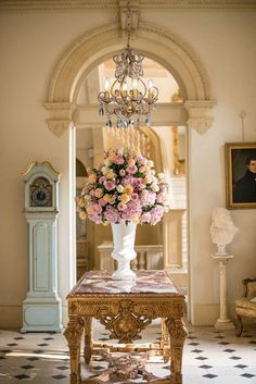 a vase filled with flowers sitting on top of a table