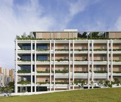 an apartment building with plants growing on the balconies