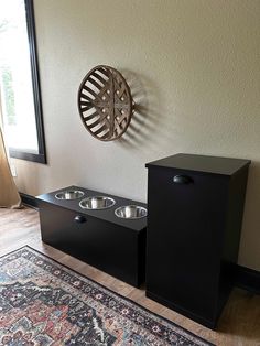 two bowls are sitting on the floor next to each other in front of a window