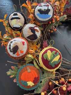 an autumn wreath made out of felt with leaves and acorns