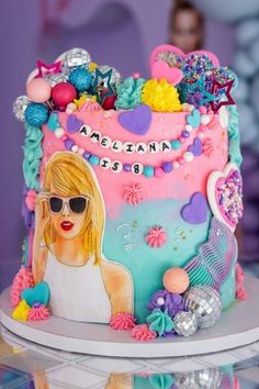 a birthday cake decorated with an image of a woman's face and accessories on it