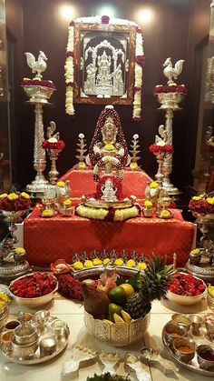 a table topped with lots of different types of food and silver wares on top of it