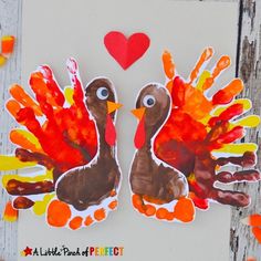 two turkeys made out of handprinted paper