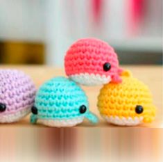 three small crocheted toys sitting on top of a table