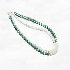 Elevate your style with the Auspicious Double Layer Green Jade Necklace, featuring antique-style mint jade Huang (璜). Revered as the emperor of gemstones, jade symbolizes virtues like grace, loyalty, and sincerity. This 16-inch necklace includes jadeite, moonstone, freshwater pearl, and a white jade Huang pendant.⚜ Auspicious Double Layer Green Jade Necklace❀ Mint Jadeite 2-4mm & Faceted Moonstone 2-3mm ❀ Green Jadeite 6mm & Fresh Water Pearl 2mm❀ Mint Jade Huang 0.5" x 1.75" (12m x 45m) ❀ Lengt Elegant Green Jade Crystal Necklace, Spiritual Jade Crystal Necklaces With Round Shape, Traditional Jade Necklace With Gemstone Beads, Green Jade Gemstone Beaded Necklace, Jade Gemstone Beads Jewelry For Meditation, Jade Amulet Necklace With Round Beads, Jade Amulet Necklaces With Round Beads, Elegant Jade Necklace For Healing, Spiritual Jade Necklaces For Meditation