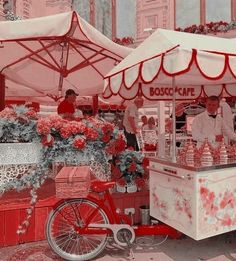 a red and white cart with flowers on it