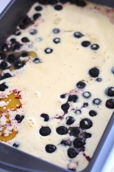 a pan filled with blueberries and cream on top of a stove