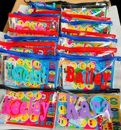 there are many bags that have the words happy on them in different colors and shapes