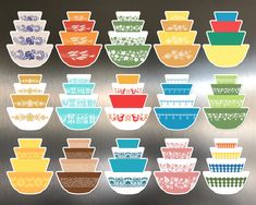 a bunch of bowls sitting on top of a metal wall next to each other in different colors