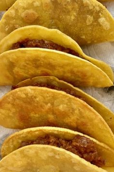 A closeup of pan fried beef tacos in a pan Mini Fried Tacos Corn Tortillas, Frying Tortillas For Tacos, How To Fry Corn Tortillas, Pan Fried Tacos Corn Tortillas, Fried Corn Tacos, How To Fry Corn Tortillas For Tacos, Fried Mini Tacos, Frying Corn Tortillas For Tacos, Oven Fried Tacos