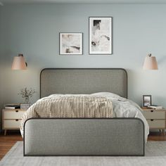 a bed sitting in a bedroom on top of a wooden floor next to two lamps