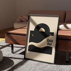 a framed poster sitting on the floor next to a couch