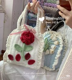 a crocheted purse with flowers on it is being held by a woman's hand