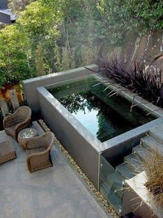 an outdoor hot tub in the middle of a garden