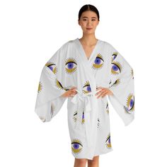 Add a touch of mystical elegance to your wardrobe with this stunning Evil Eye Purple & Gold Long Sleeve Kimono Robe! Made from luxurious, lightweight fabric, this kimono robe features a mesmerizing evil eye design in vibrant purple and gold hues. Perfect for lounging at home or making a statement at a special event, this robe adds a unique and stylish flair to any outfit. Embrace the intrigue and beauty of the evil eye symbol with this gorgeous kimono robe. Whether it's lounging at home or makin White V-neck Kimono For Daywear, White Robe With Kimono Sleeves For Loungewear, White Wrap Kimono For Loungewear, White Kimono With Kimono Sleeves For Daywear, White Printed Kimono For Loungewear, White Kimono Sleeve Robe For Daywear, White Sleepwear With Kimono Sleeves, White Kimono-sleeved Robe For Daywear, Evil Eye Purple