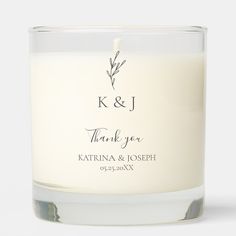 a white candle with the words k & j on it