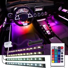 the interior of a car with various colored lights and remote controls on it's dashboard