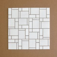 a white tile pattern on a brown background