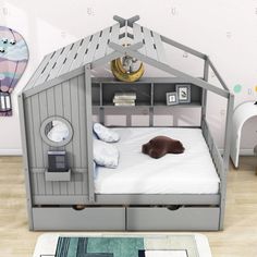 a child's bed in the shape of a house