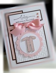 a handmade card with a baby's foot and pink ribbon on the front