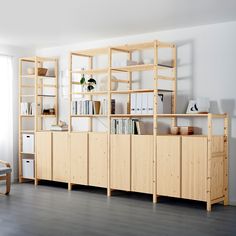 an empty room with wooden shelves and bookshelves