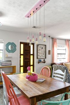 a dining room table with chairs and a bowl on it