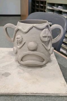 a ceramic mug sitting on top of a table