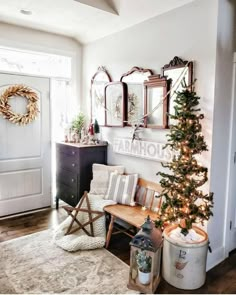 a living room with a christmas tree in the corner and other decorations on the wall