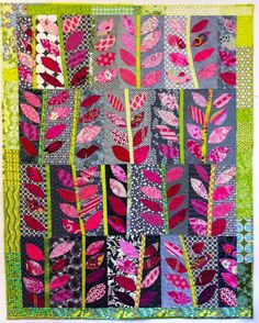 a quilted wall hanging with pink, green and purple leaves on the bottom half