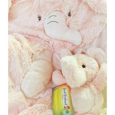 there is a pink teddy bear next to a white stuffed animal