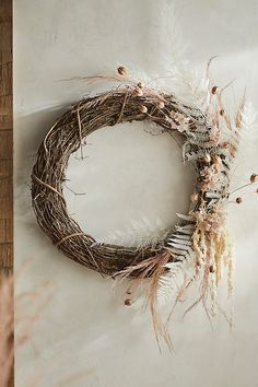 a dried wreath is hanging on the wall