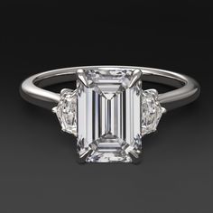 an emerald cut diamond ring with three side stones