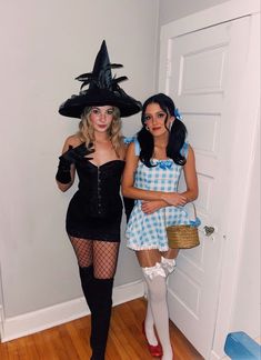 two women dressed in costumes posing for the camera