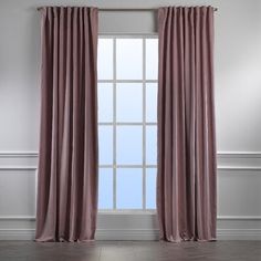 an open window with pink curtains hanging on the wall and wooden floors in front of it