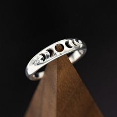 Product Details Ring Style: "Nera" is ahandcrafted, custom wedding ring featuring the phases of the moon with two diamond accents. This ring is pictured in silver. Width:The width of the ring pictured is approximately 5mm wide. Customizable:Because each ring is handcrafted to order, we can customize yours using unique materials, gemstones, or design features, often without any added cost! We can even use personal materials that you send! Basic customizations (material swaps, width changes, etc…) Cute Rings Silver Unique, Formal Moon Phase Sterling Silver Jewelry, Celestial Wedding Rings With Polished Finish, Celestial Half Moon Wedding Jewelry, Elegant Sterling Silver Rings With Moon Charm, Sterling Silver Moon Phase Jewelry For Promise, Engraved Moon Shaped Jewelry For Wedding, Crescent Moon Phase Wedding Jewelry, Engraved Moon Shaped Wedding Jewelry