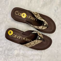 Stylish Brown Platform Flip Flops With Signature Ck Logo Stamp. The Shoes Have Never Been Worn And Still Have The Size Sticker. Brand: Calvin Klein Color: Brown And Tan Size: 8 Condition: New Without Tags (Nwot) Flip Flop Wedges, Sticker Brand, Ck Logo, Platform Flip Flops, Wedge Flip Flops, Calvin Klein Shoes, Logo Stamp, Womens Shoes Wedges, Womens Calvin Klein