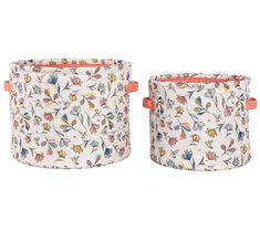 two white flower pots with orange handles on each one and the other is made out of fabric