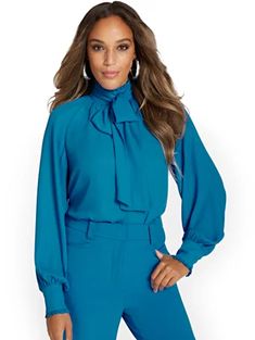 Shop Tall Ruffle Bow-Neck Blouse. Find your perfect size online at the best price at New York & Company. Trendy Tie Neck Top For Office, Trendy Tie Neck Office Tops, Blue Tie Neck Top For Office, Chic Tie Neck Tops For Workwear, Chic Blouse With Collar For Office Wear, Trendy Fitted Tie Neck Blouse, Trendy Tie Neck Blouse For Office, Chic Tops With Blouson Sleeves For Office Wear, Chic Blouson Sleeve Tops For Office Wear