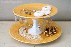 three tiered tray with jewelry on it