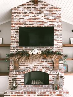 a brick fireplace with a flat screen tv above it