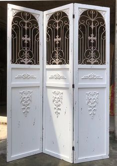 two white doors with intricate designs on them