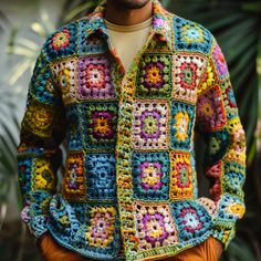 a man is wearing a colorful crocheted jacket