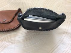 "This double coin purse is made with soft cowhide leather, a pocket on both sides with snaps, and even a pocket between the two . Hand laced and stitched to make it stronger, secured with a rivet on each side for strength, will make a nice gift. About 5-1/4\" wide x 3-1/2\" height closed. This coin purse will hold quite a few coins, bills, and one side will easily hold 13 or more credit cards. Terrific gift. Holds lots of money. Shipping insurance is included with postage. If you order multiple Leather Coin Purse With Card Slots For Daily Use, Leather Coin Purse With Interior Card Slots, Leather Coin Purse With Cell Phone Pocket, Handmade Leather Coin Purse Clutch, Leather Clutch Coin Purse With Cell Phone Pocket, Handmade Leather Coin Clutch, Handmade Leather Clutch Coin Purse, Leather Coin Purse With Cell Phone Pocket As Gift, Leather Coin Purse With Card Slots