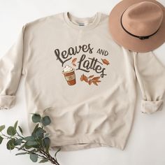 Our fall leaves and pumpkin spice latte coffee cup shirt is a great addition to your fall tee collection! Perfect for all of your fall activities: grabbing coffee, hanging out at the ball field, or under a cute jacket or sweater by the bonfire! Makes a great gift too! SIZE UP for an OVERSIZED FIT (see size chart in listing photos). Are you looking for additional Fall or Halloween themed graphic tees? Check out the following: https://www.etsy.com/shop/TheGraphicPeach?ref=seller-platform-mcnav§ion Coffee Colored Tops With Letter Print For Fall, Coffee Letter Print Tops For Fall, Relaxed Fit Coffee Color Tops For Fall, Fall Coffee Cotton Sweatshirt, Fall Cotton Coffee Sweatshirt, Coffee-colored Graphic Print Sweatshirt For Fall, Coffee Cotton Sweatshirt For Fall, Coffee Color Cotton Sweatshirt For Fall, Casual Coffee Sweatshirt For Fall