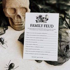 a family feud card sitting on top of a table next to a human skull