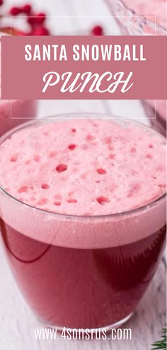 a pink drink in a glass with the words santa snowball punch