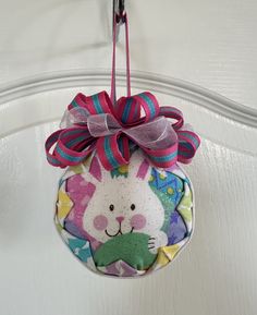 an ornament hanging from a door with a bunny on it