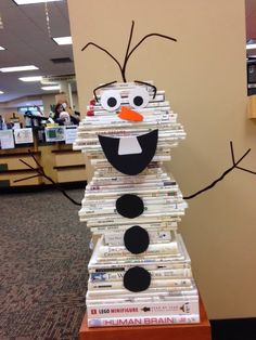 a stack of books that have been made to look like a snowman sitting on top of each other